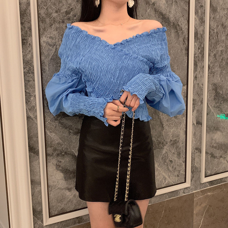 Burq | Modern off-shoulder blouseshirt met pofmouwen